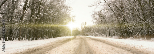 the snowy highway road going through the forest and trees, winter season, wide banner