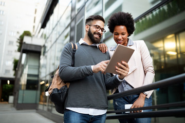 Couple, business, technology concept. Businessman with tablet and woman with smartphone talking