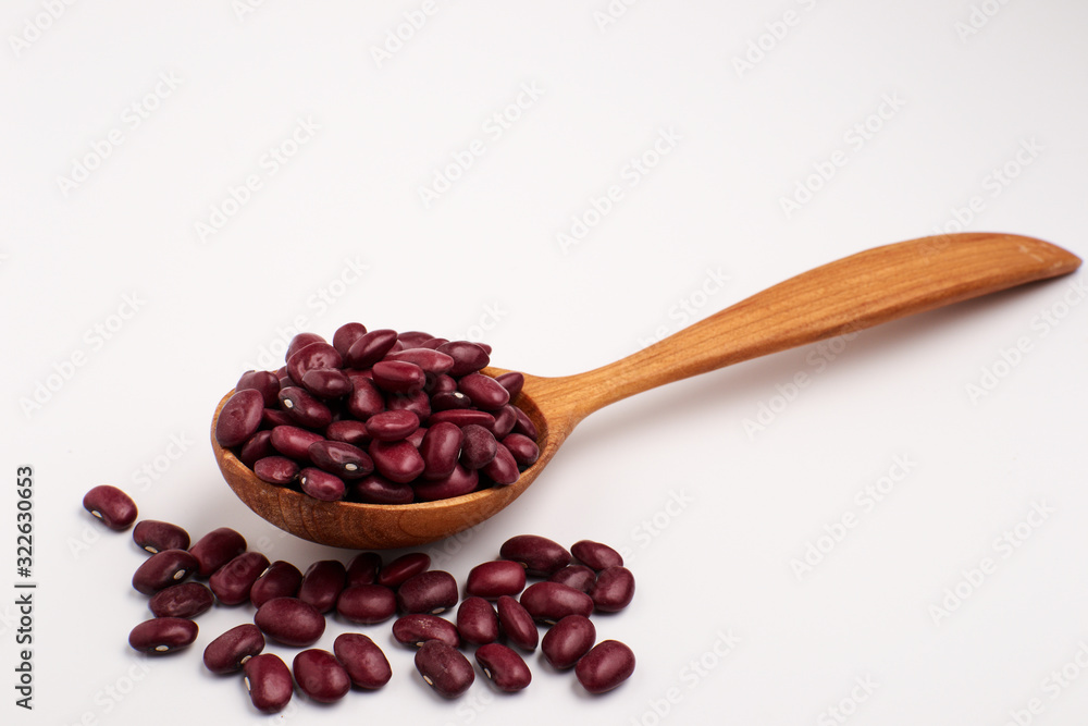 Red beans in wooden spoon, isolated. Red beans in wooden spoon, isolated.