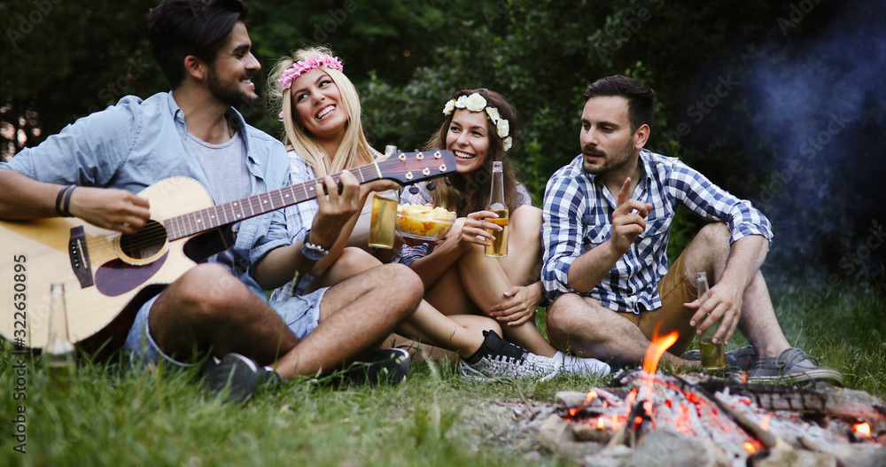Friends having bonfire party anf fun together Friends having bonfire party anf fun together