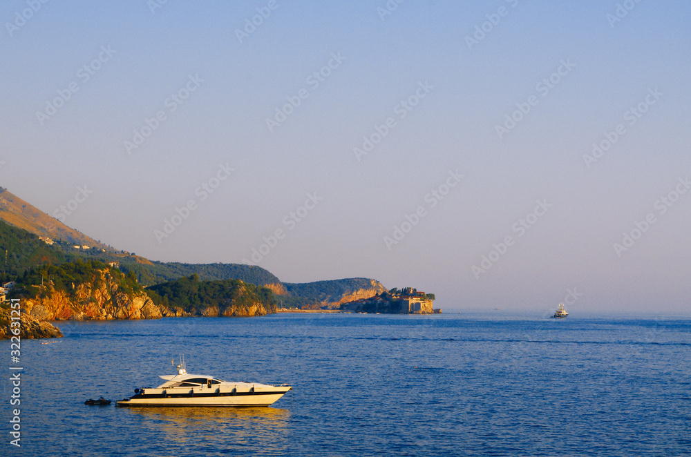 Montenegro, Budva. Sea and mountains. A ship in the sea. Incredible summer landscape