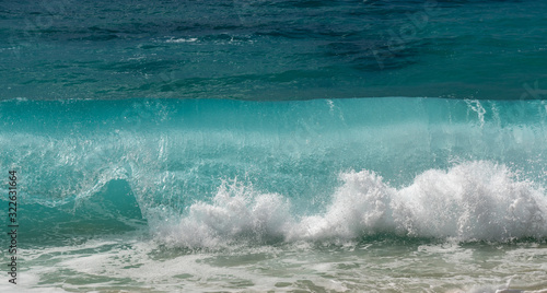 Frozen motion of water droplets at the crest of ocean waves off the coast of Hawaii