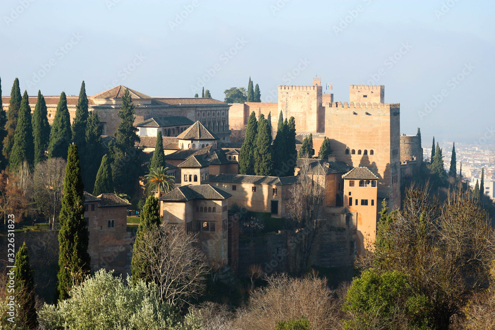 Panoramic view of the Alhambra citadel and palaces from Generalife gardens in foggy winter morning