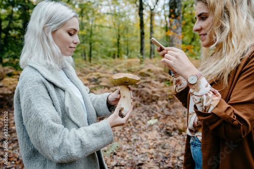 Women sharing a picture of a giant mushroom she found in the forest photo