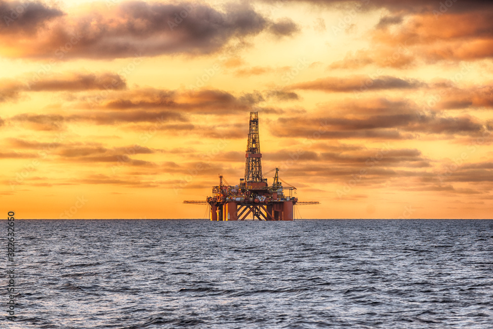 HDR of Offshore Jack Up Rig in The Middle of The Sea at Sunset Time