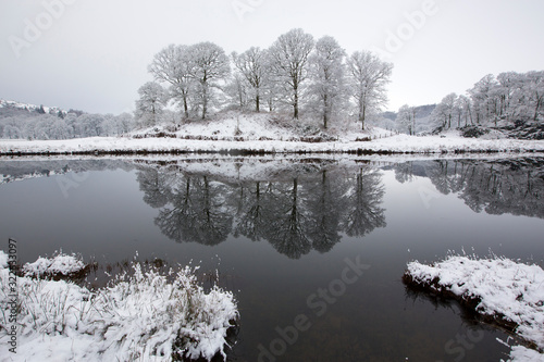 Refelctions in the River Brathay after an overnight fall of snow in the Langdale Valley, Lake District, UK. Taken on 17th January 2016. photo