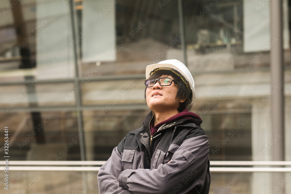 young man outside with helmet standing young man outside with helmet standing