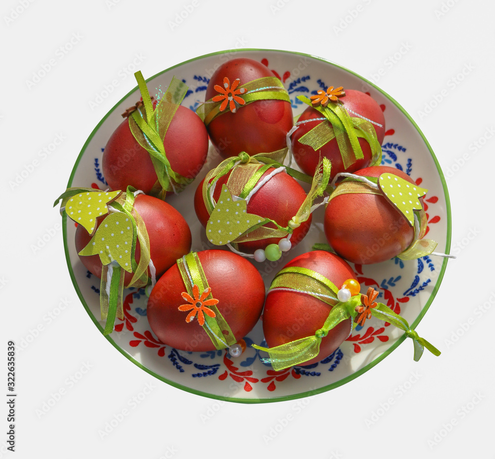 Easter eggs decorated with ribbons on a plate. Easter eggs decorated with ribbons on a plate.