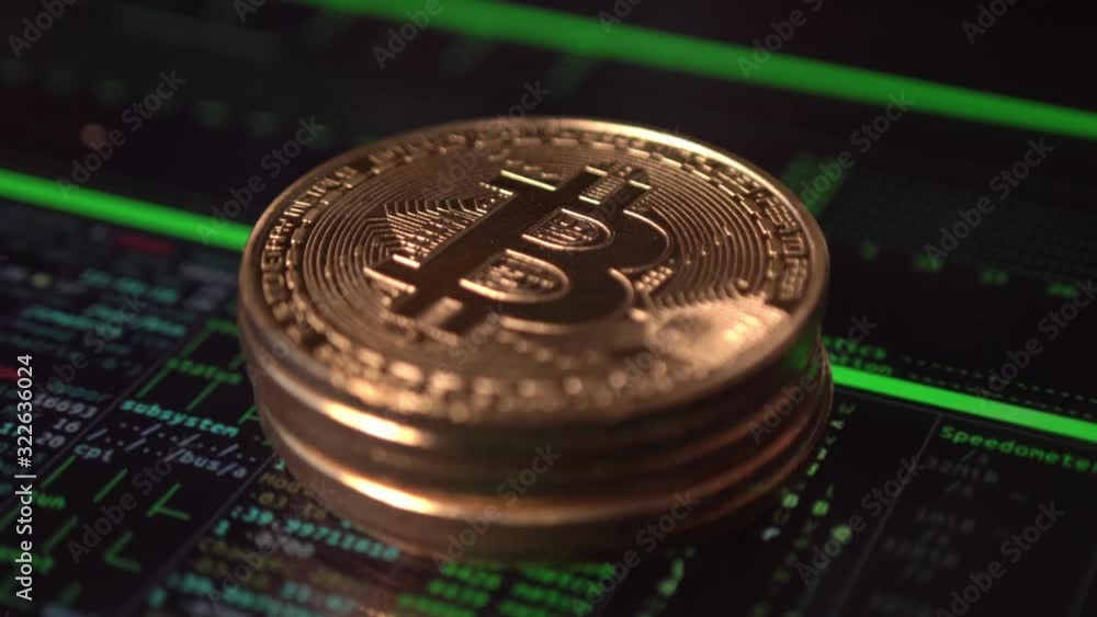 Stack of bitcoins on screen generating programming code Stack of bitcoins on screen generating programming code