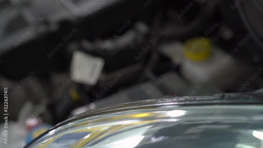 Headlights and hood of car open at service station internal parts engine inside of the machine vehicle motor repair camera movement Headlights and hood of car open at service station internal parts engine inside of the machine vehicle motor repair camera movement