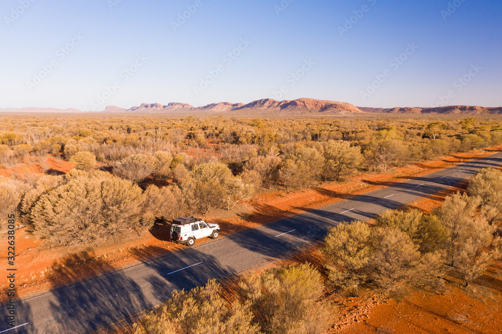 Aerial view of a car on a road with vegetation, Standley Chasm, Hugh, Australia Aerial view of a car on a road with vegetation, Standley Chasm, Hugh, Australia