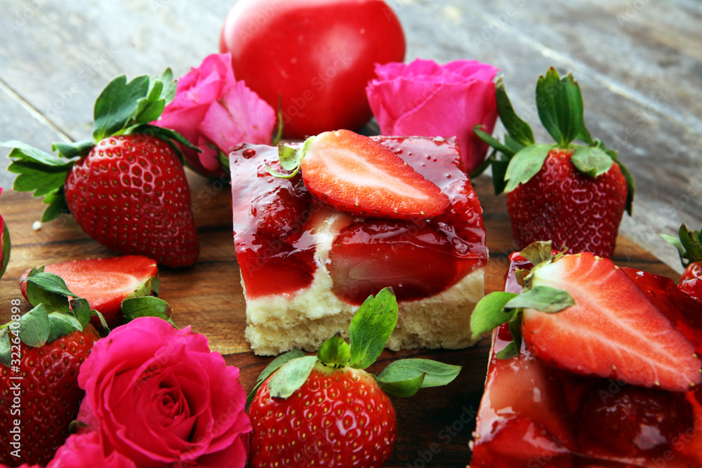 strawberry cake and many fresh strawberries on rustic table with hearts and roses for valentines day. strawberry cake and many fresh strawberries on rustic table with hearts and roses for valentines day.