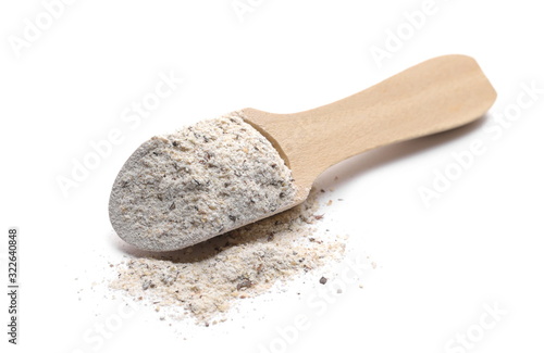 Buckwheat integral flour pile with wooden spoon isolated on white background 