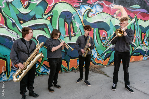 High school jazz band brass musicians by graffiti mural photo