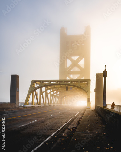 Canvas Print Foggy Tower Bridge Sacramento and a cyclist