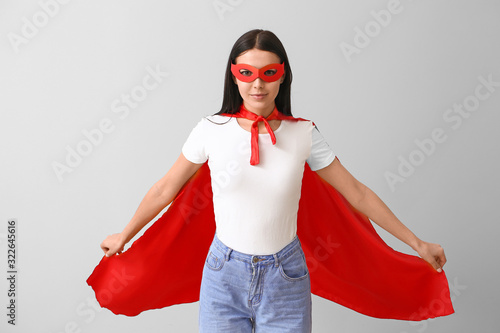 Woman in superhero costume ...
