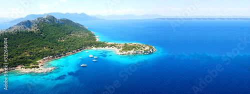 Aerial drone ultra wide photo of paradise small island of Moni visited by sail boats and yachts with turquoise clear seascape, Aegina island, Saronic gulf, Greece