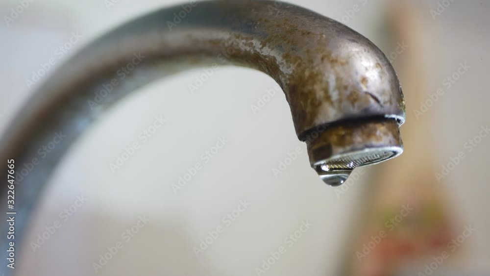 dripping old, rusty kitchen faucet. water dripping from a tap close up. Lack of clean water, reckless use of resources dripping old, rusty kitchen faucet. water dripping from a tap close up. Lack of clean water, reckless use of resources