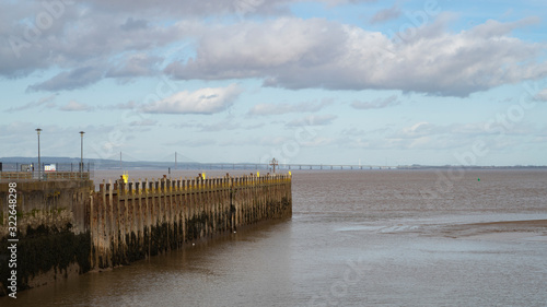 A view of the Severn Estuary near Bristol  England UK with the new road bridge in the distance and Portishead pier in the foreground.