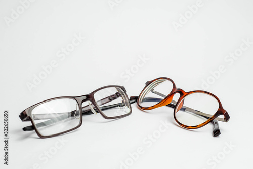Two pairs of modern of glasses isolated in a studio shot one with black and turquoise colored frames and a blue blocking pair prescribed from a profession optometrist Copy Space Illustrative photo