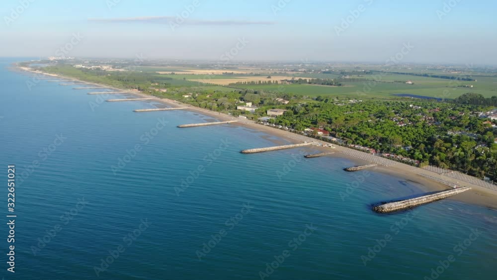 Aerial shot of the coast of Caorle and the rural area surrounding the city of Venice at sunrise Aerial shot of the coast of Caorle and the rural area surrounding the city of Venice at sunrise