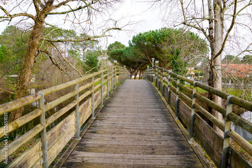 wood pedestrian bridge beach access in Sanguinet lake