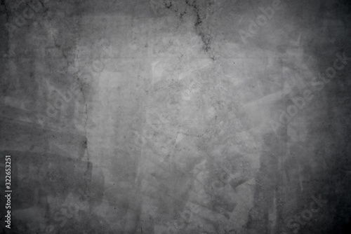 Dark grunge concrete texture with vignette as a background
