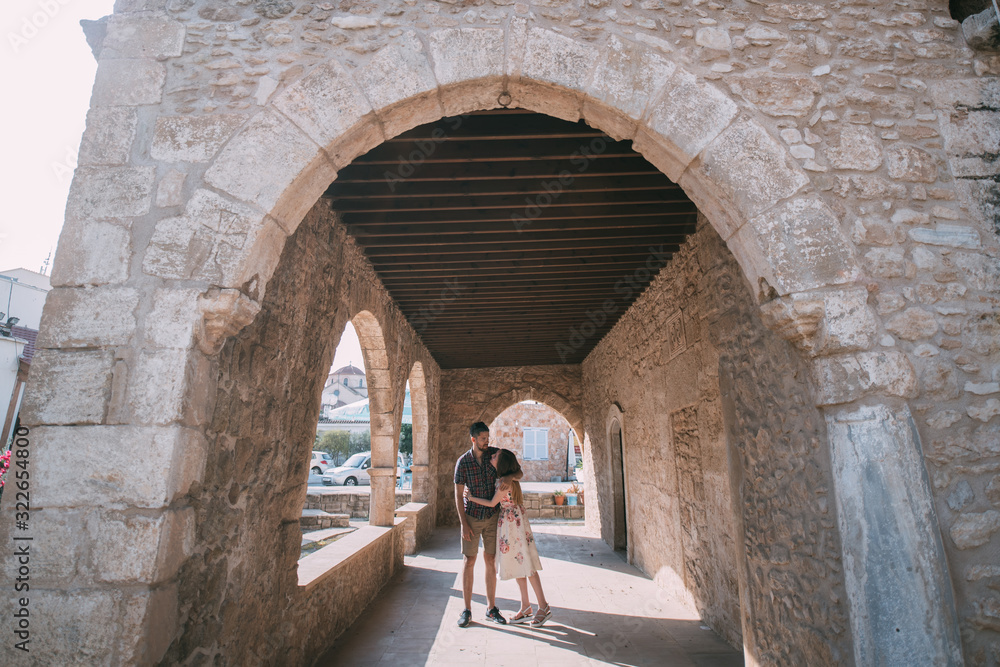 A young couple of lovers on the background of an ancient temple