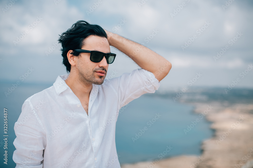 A man on the rocks overlooking the sea A man on the rocks overlooking the sea