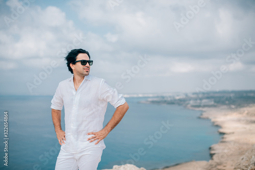 A man on the rocks overlooking the sea
