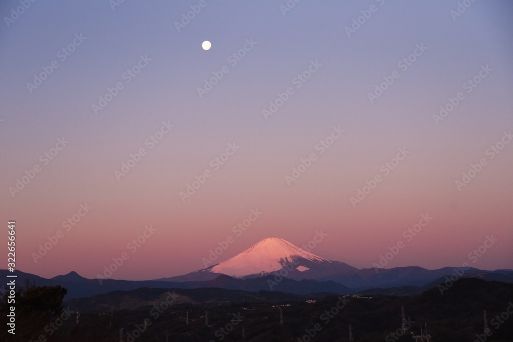 Dawn moon and Mt. Fuji dyed red at sunrise.