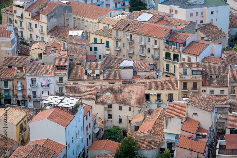 Panorama view on cityscape of Cefalu from drone. Roofs of houses with terraces close-up. Sicily, Italy