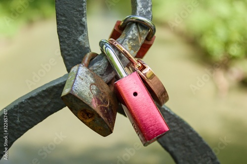 Love lock locks hang from a bridge