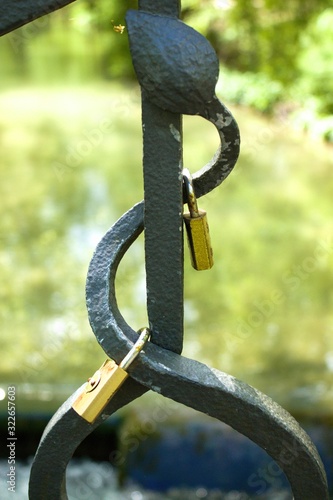 Love lock locks hang from a bridge