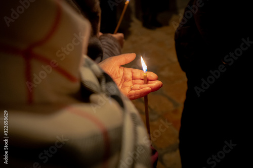 Candle in a woman's hand. Symbol and flame