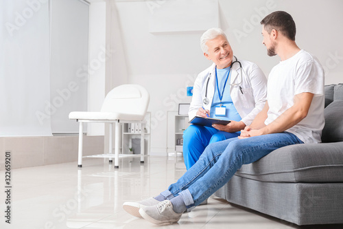 Mature male doctor working ...