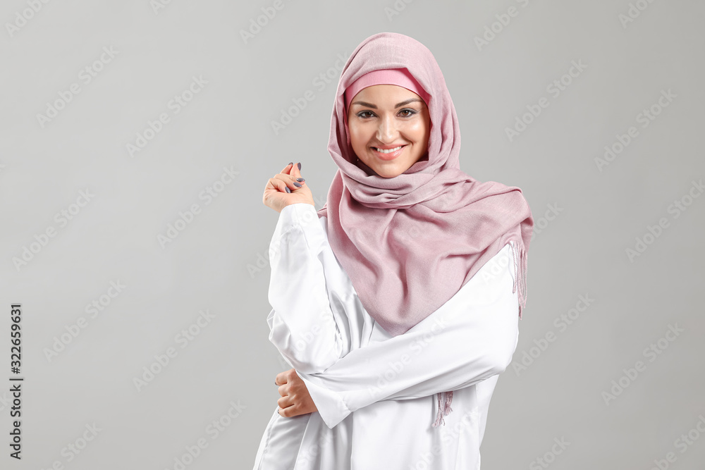 Beautiful Arab woman on grey background Beautiful Arab woman on grey background