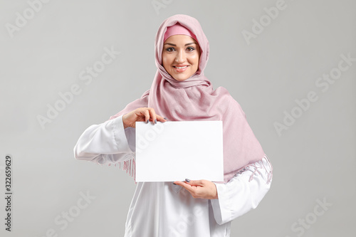Young Arab woman with blank...