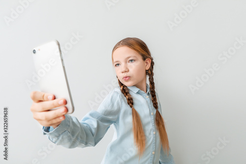 Cute little girl taking sel...