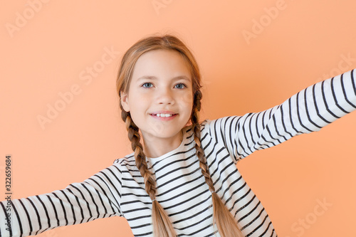 Cute little girl taking sel...