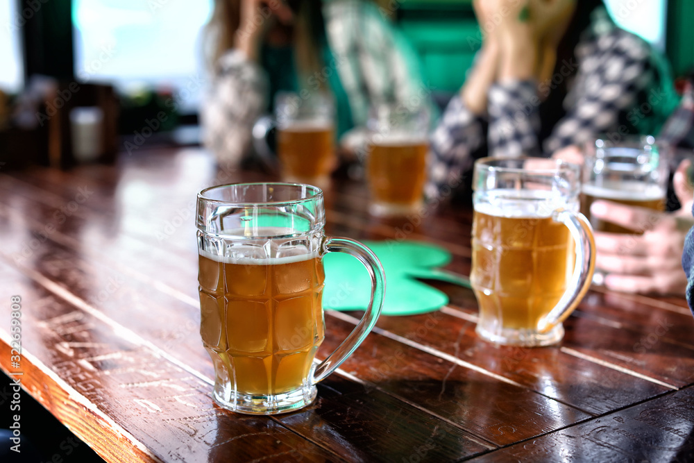 Mug of beer on table in pub. St. Patrick's Day celebration Mug of beer on table in pub. St. Patrick's Day celebration
