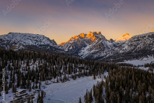 An incredible sunset in the Dolomites Alps in the Tre Cime di Lavaredo national park in january 2020 in Italy. Aerial drone shot