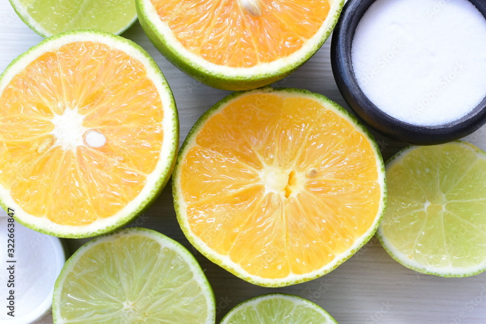 Obraz premium Tahiti lemons and whole and sliced oranges