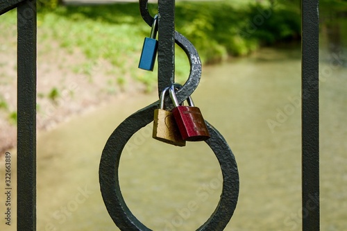 Love lock locks hang from a bridge