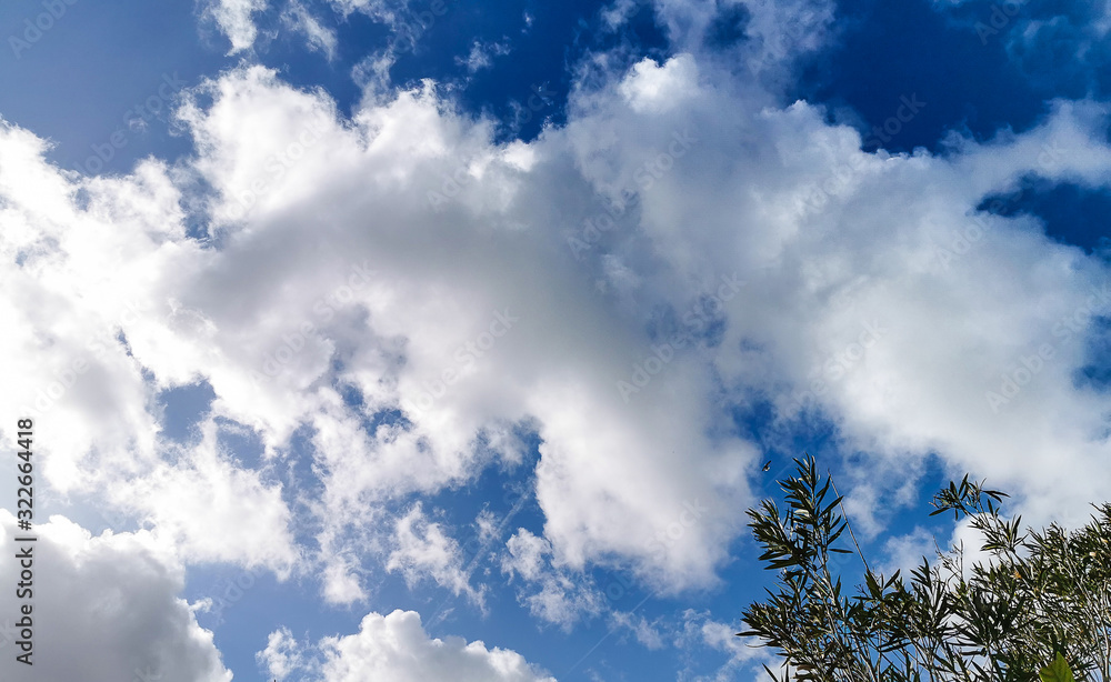 Sunny day, bright blue sky with clouds background for design, decoration or wallpaper Sunny day, bright blue sky with clouds background for design, decoration or wallpaper