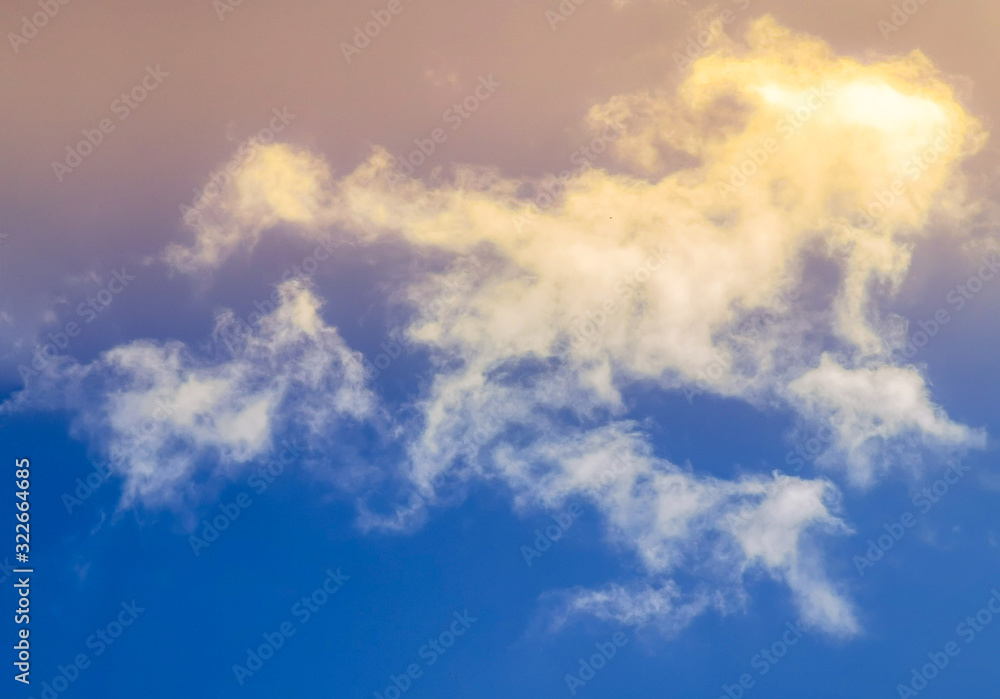 Bright blue sky with clouds with sunset lights, background for design, decoration or wallpaper Bright blue sky with clouds with sunset lights, background for design, decoration or wallpaper