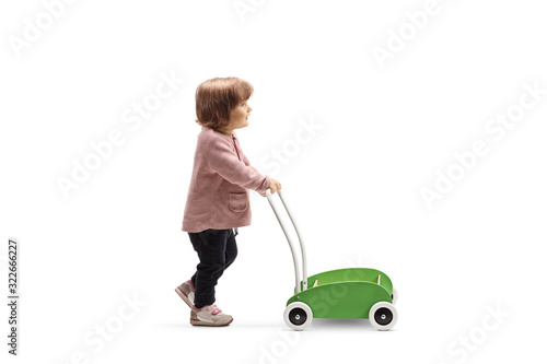 Toddler girl pushing a toy cart