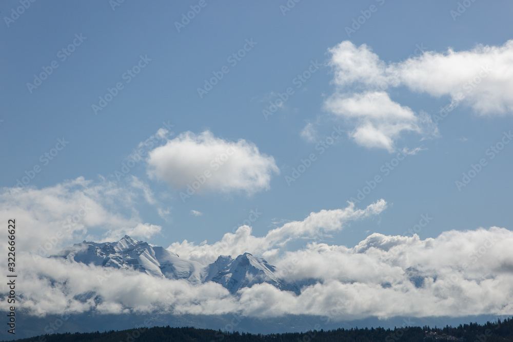 Rocky mountains peaking through clouds Rocky mountains peaking through clouds