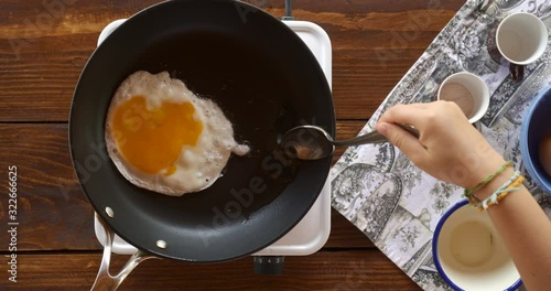 Top view food. Cooking With Mother. Beautiful Little Girl Learns How To Make Fried Egg.