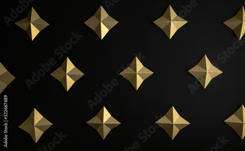Luxury geometric gold stars on black paper background pattern